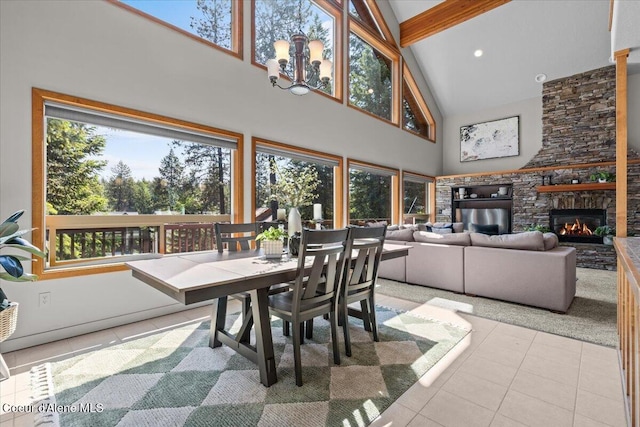 106 Stewart Dr, Blanchard, ID 83804 - tiled dining area featuring high vaulted ceiling, beam ceiling, and a stone fireplace