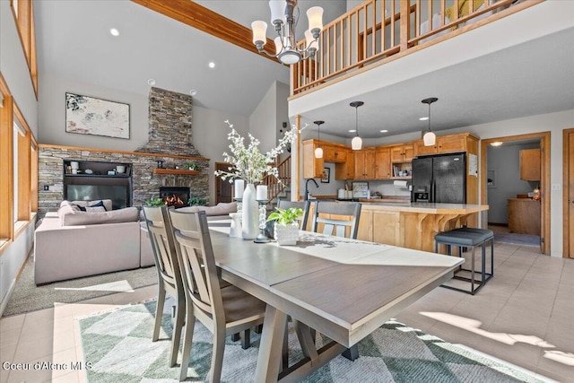 106 Stewart Dr, Blanchard, ID 83804 - dining room featuring high vaulted ceiling, light tile patterned floors, a fireplace, a chandelier, and recessed lighting