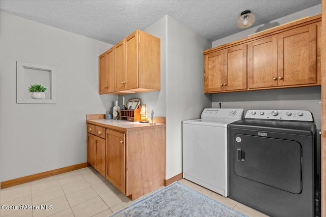 106 Stewart Dr, Blanchard, ID 83804 - laundry room with independent washer and dryer, baseboards, light tile patterned flooring, cabinet space, and a textured ceiling