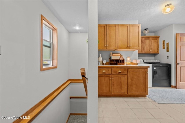 106 Stewart Dr, Blanchard, ID 83804 - kitchen featuring light countertops, brown cabinets, light tile patterned flooring, a textured ceiling, and baseboards