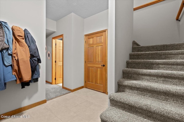 106 Stewart Dr, Blanchard, ID 83804 - stairway featuring baseboards and a textured ceiling