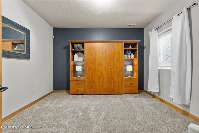 106 Stewart Dr, Blanchard, ID 83804 - unfurnished bedroom featuring carpet floors, baseboards, and a textured ceiling