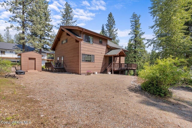 106 Stewart Dr, Blanchard, ID 83804 - rear view of house featuring a wooden deck and driveway