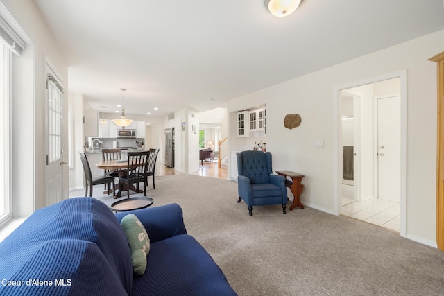 4950 E Frazier Dr, Post Falls, ID 83854 - living area featuring light colored carpet, healthy amount of natural light, and baseboards