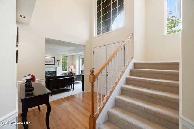 4950 E Frazier Dr, Post Falls, ID 83854 - staircase featuring wood finished floors, a fireplace, and a towering ceiling