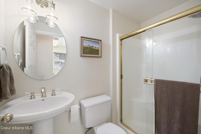 4950 E Frazier Dr, Post Falls, ID 83854 - full bathroom with a stall shower, toilet, and a sink