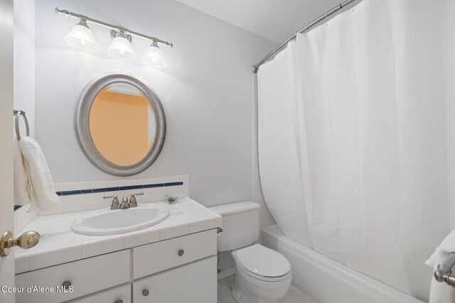 4950 E Frazier Dr, Post Falls, ID 83854 - bathroom with vanity, toilet, and shower / tub combo with curtain