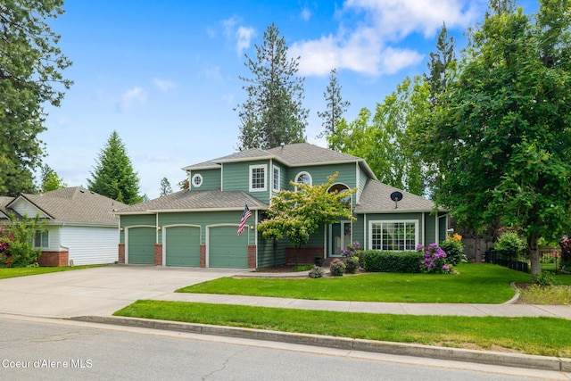 4950 E Frazier Dr, Post Falls, ID 83854 - view of front facade featuring driveway, a front lawn, a garage, and brick siding