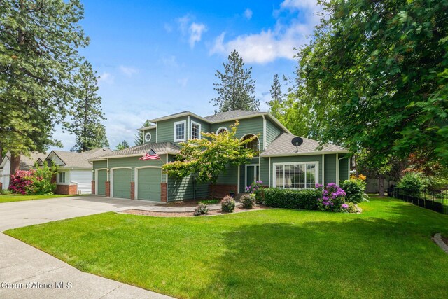 4950 E Frazier Dr, Post Falls, ID 83854 - view of front of home featuring driveway, a shingled roof, and an attached garage