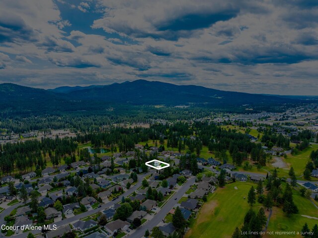 4950 E Frazier Dr, Post Falls, ID 83854 - aerial overview of property's location featuring mountains, property parcel outlined, and nearby suburban area