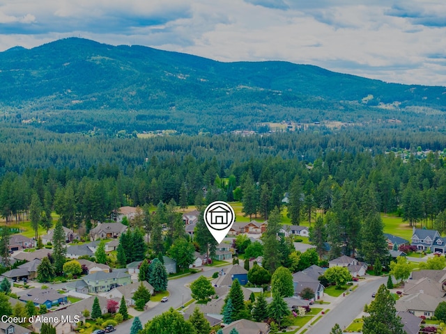 4950 E Frazier Dr, Post Falls, ID 83854 - aerial view of residential area with a mountainous background and a heavily wooded area