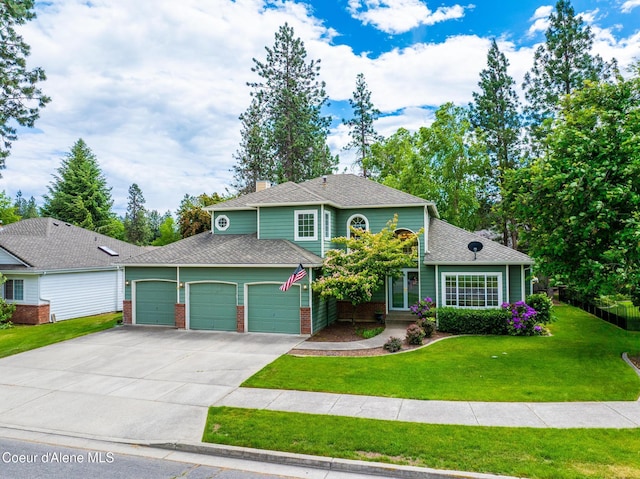 4950 E Frazier Dr, Post Falls, ID 83854 - traditional-style home featuring an attached garage, driveway, a front yard, brick siding, and a shingled roof