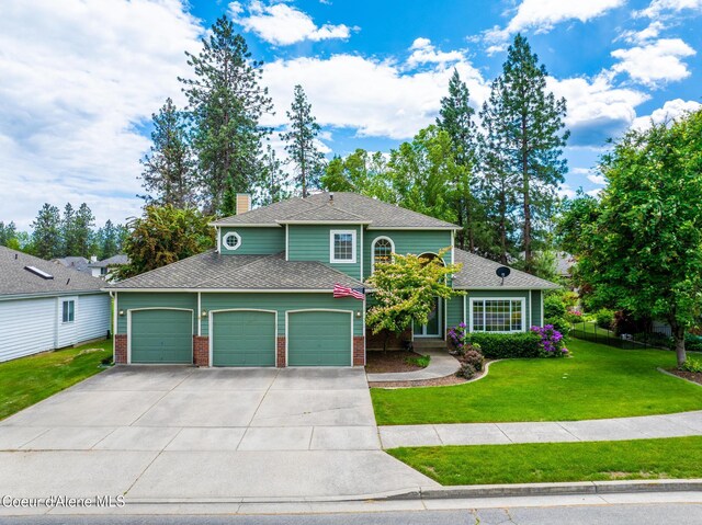 4950 E Frazier Dr, Post Falls, ID 83854 - view of front facade featuring an attached garage, driveway, a chimney, brick siding, and a shingled roof