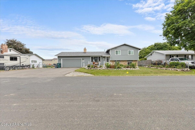 9670 N Meadow Way, Hayden, ID 83835 - tri-level home with an attached garage, a chimney, and asphalt driveway