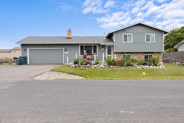 9670 N Meadow Way, Hayden, ID 83835 - tri-level home featuring a garage, a chimney, driveway, and brick siding