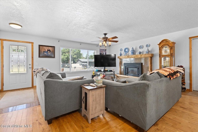 9670 N Meadow Way, Hayden, ID 83835 - living area featuring a textured ceiling, a ceiling fan, and light wood-style flooring