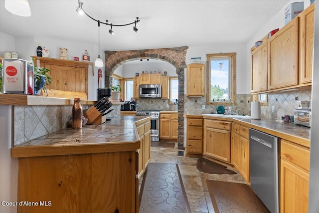 9670 N Meadow Way, Hayden, ID 83835 - kitchen featuring stainless steel appliances, tasteful backsplash, decorative light fixtures, and stone finish floors
