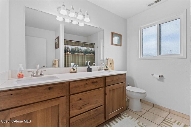 9670 N Meadow Way, Hayden, ID 83835 - full bath with double vanity, tile patterned floors, toilet, and a shower with curtain