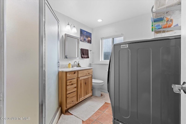 9670 N Meadow Way, Hayden, ID 83835 - full bathroom featuring vanity, tile patterned floors, toilet, and a shower