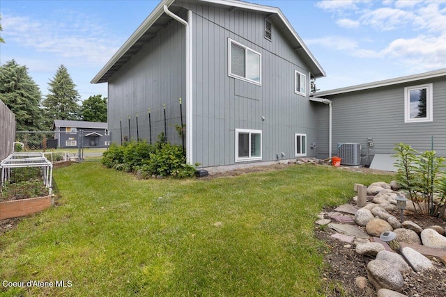 9670 N Meadow Way, Hayden, ID 83835 - rear view of property featuring central AC and a vegetable garden
