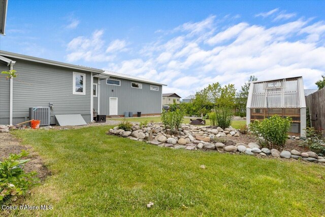 9670 N Meadow Way, Hayden, ID 83835 - view of grassy yard featuring cooling unit and an exterior structure