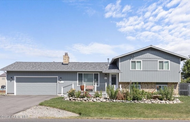 9670 N Meadow Way, Hayden, ID 83835 - split level home with an attached garage, a chimney, driveway, brick siding, and a shingled roof