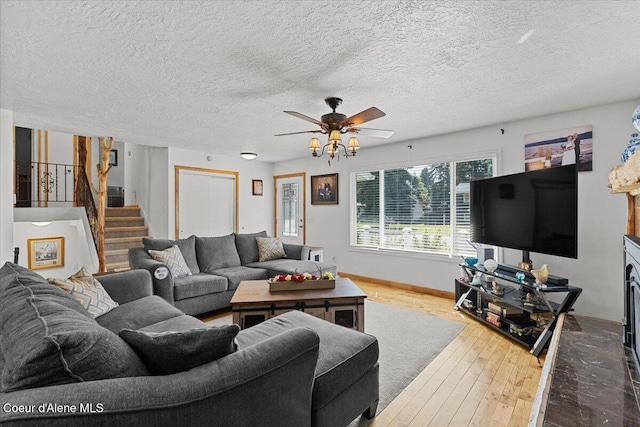 9670 N Meadow Way, Hayden, ID 83835 - living room with a ceiling fan, stairway, hardwood / wood-style flooring, and a textured ceiling