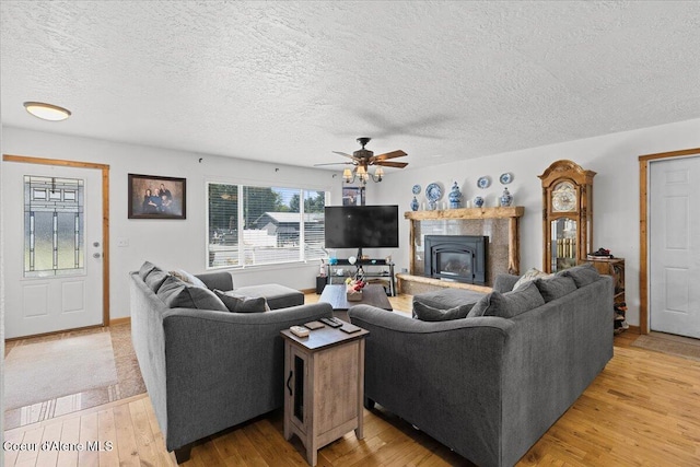 9670 N Meadow Way, Hayden, ID 83835 - living area featuring ceiling fan, light wood-style floors, and a textured ceiling