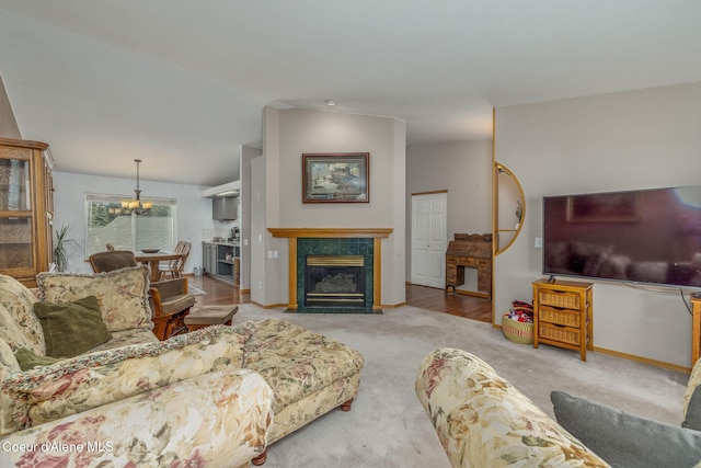 8846 N Clarkview Pl, Hayden, ID 83835 - living area featuring carpet floors, a chandelier, vaulted ceiling, and a tiled fireplace