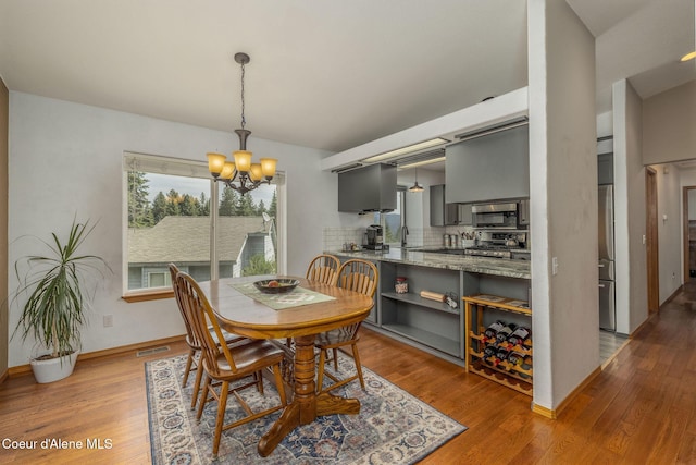 8846 N Clarkview Pl, Hayden, ID 83835 - dining room with a chandelier and wood finished floors