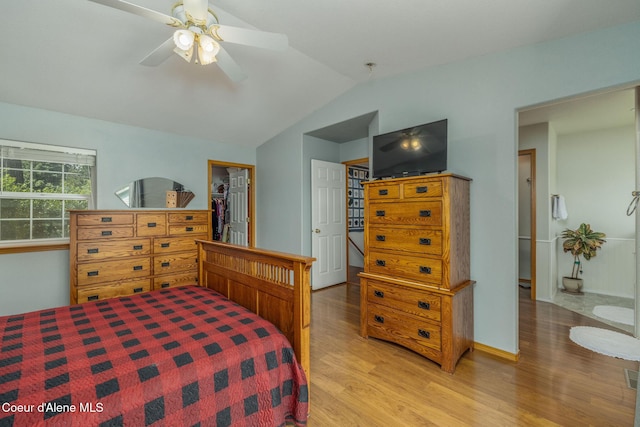 8846 N Clarkview Pl, Hayden, ID 83835 - bedroom with light wood-style flooring, lofted ceiling, a walk in closet, a closet, and a ceiling fan