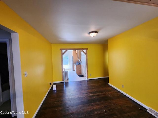 607 W Riverside Ave, Kellogg, ID 83837 - spare room featuring wood finished floors and baseboards