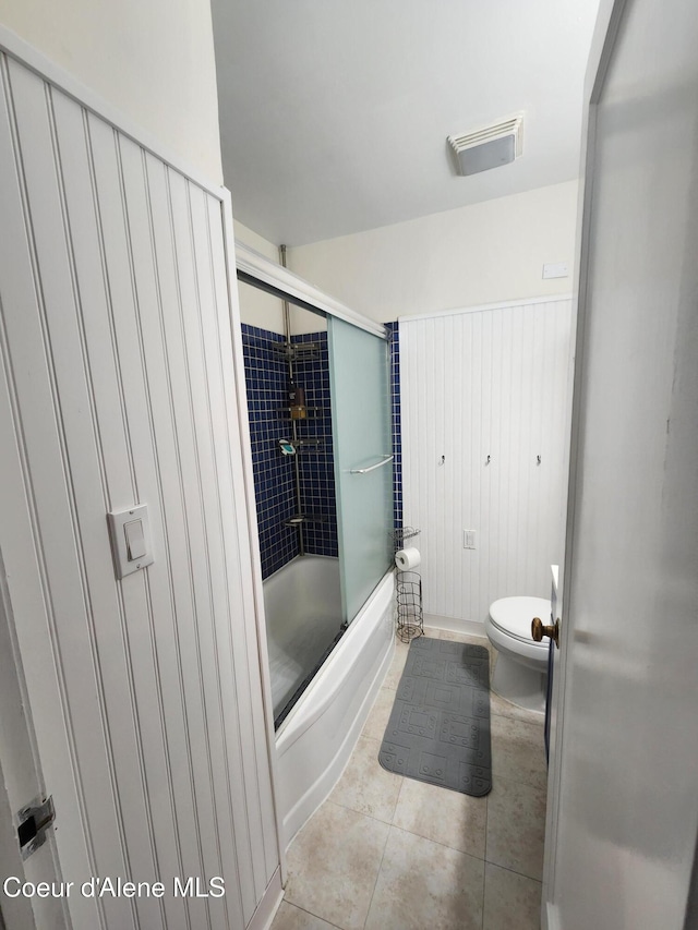 607 W Riverside Ave, Kellogg, ID 83837 - full bathroom featuring toilet, shower / bath combination with glass door, and tile patterned flooring