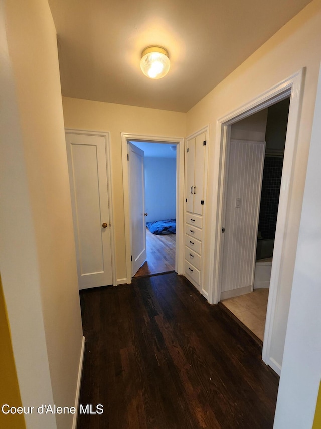 607 W Riverside Ave, Kellogg, ID 83837 - hall featuring dark wood-style flooring and baseboards