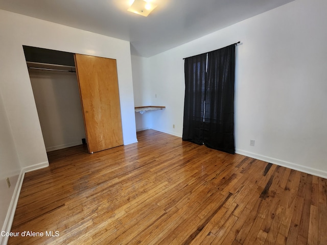 607 W Riverside Ave, Kellogg, ID 83837 - unfurnished bedroom with hardwood / wood-style floors, a closet, and baseboards