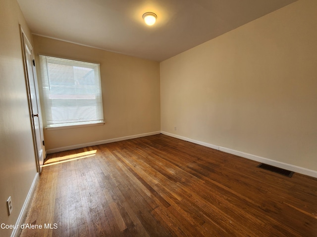 607 W Riverside Ave, Kellogg, ID 83837 - spare room with wood-type flooring and baseboards