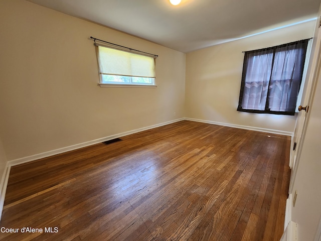 607 W Riverside Ave, Kellogg, ID 83837 - spare room featuring dark wood-type flooring and baseboards