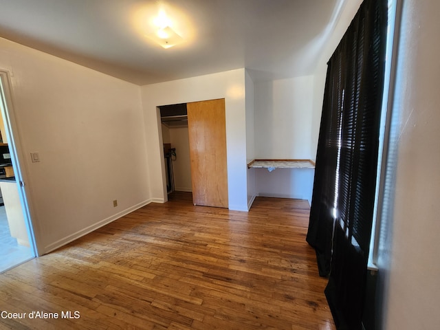 607 W Riverside Ave, Kellogg, ID 83837 - unfurnished bedroom featuring hardwood / wood-style flooring, a closet, and baseboards