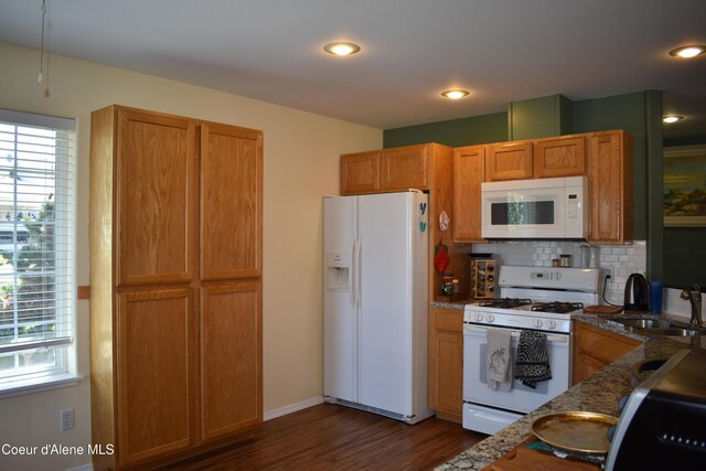 1406 Walnut, Sandpoint, ID 83864 - kitchen with white appliances, a sink, dark wood-style flooring, backsplash, and dark stone countertops