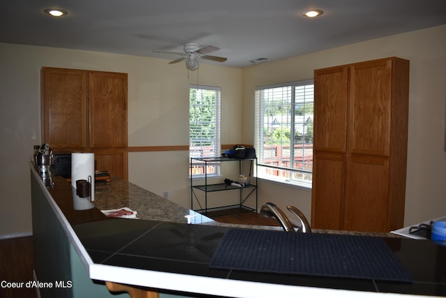 1406 Walnut, Sandpoint, ID 83864 - kitchen with a ceiling fan, brown cabinetry, wood finished floors, recessed lighting, and dark countertops