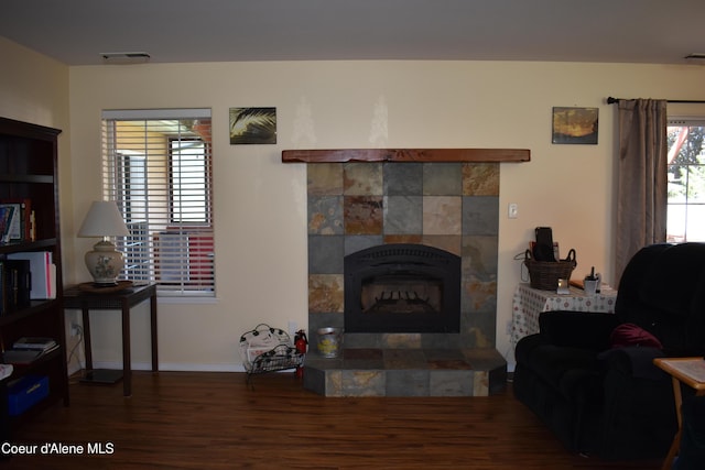 1406 Walnut, Sandpoint, ID 83864 - living area with wood finished floors, a tiled fireplace, and baseboards