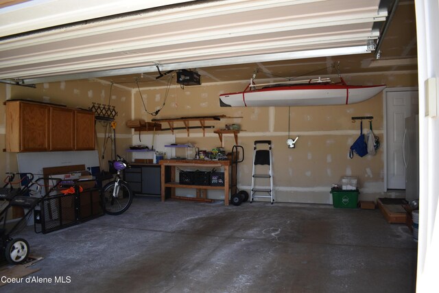 1406 Walnut, Sandpoint, ID 83864 - garage with a garage door opener and freestanding refrigerator