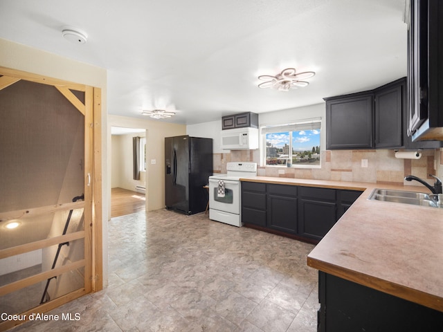 409 N 2nd St, Fairfield, WA 99012 - kitchen featuring white appliances, a sink, backsplash, light countertops, and dark cabinetry