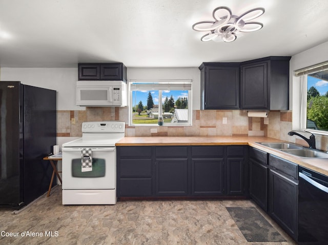 409 N 2nd St, Fairfield, WA 99012 - kitchen featuring black appliances, a sink, decorative backsplash, and light countertops