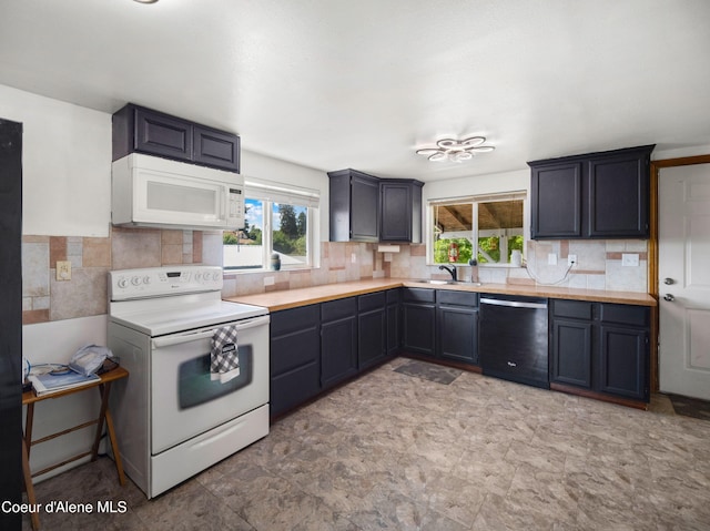 409 N 2nd St, Fairfield, WA 99012 - kitchen with white appliances, a sink, plenty of natural light, and light countertops