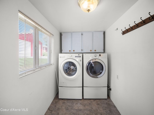 409 N 2nd St, Fairfield, WA 99012 - laundry room featuring washing machine and dryer, cabinet space, and stone finish flooring