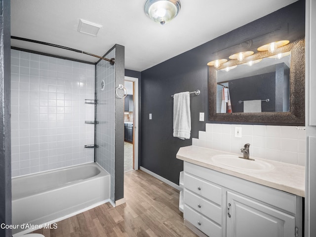 409 N 2nd St, Fairfield, WA 99012 - bathroom featuring vanity, wood finished floors,  shower combination, decorative backsplash, and baseboards