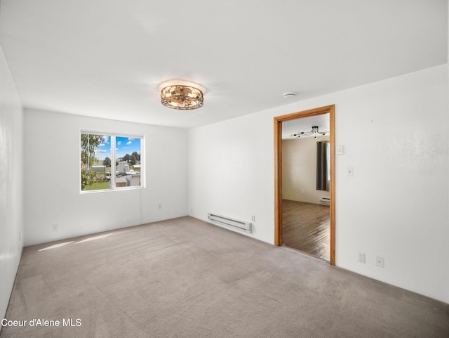 409 N 2nd St, Fairfield, WA 99012 - carpeted empty room with a baseboard radiator and a smoke detector