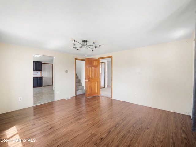 409 N 2nd St, Fairfield, WA 99012 - unfurnished room featuring a chandelier, stairs, and wood finished floors