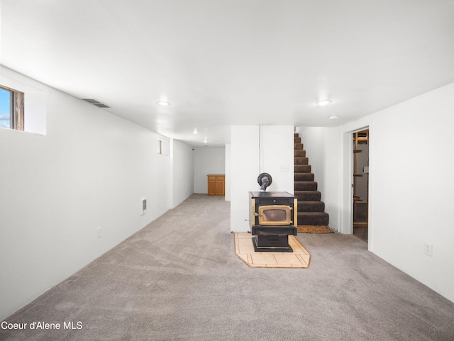 409 N 2nd St, Fairfield, WA 99012 - below grade area featuring a wood stove, carpet floors, stairs, and recessed lighting